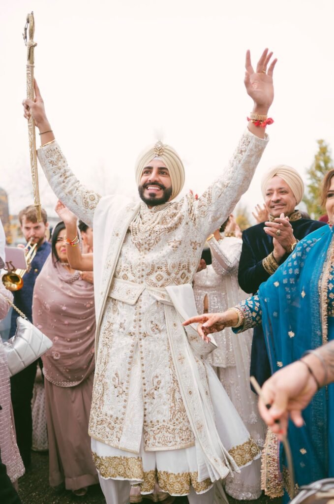 Sikh Anand Karaj Maharaja Sherwani in white with sword, shawl, belt and necklace.