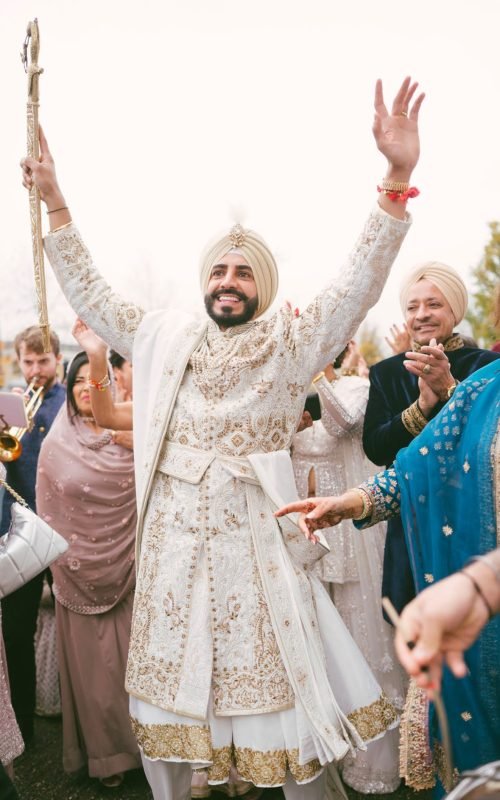 Sikh Anand Karaj Maharaja Sherwani in white with sword, shawl, belt and necklace.