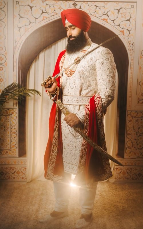 Groom in Maharaja Sherwani with Red Shawl and Traditional Red Turban